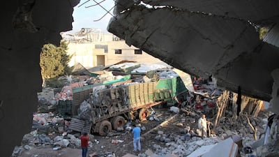 At least 18 out of 31 lorries in an aid convoy were destroyed in the town of Orum al-Kubra on the western outskirts of Aleppo, Syria on September 20, 2016, after being hit by an air strike. Omar Haj Kadour / AFP