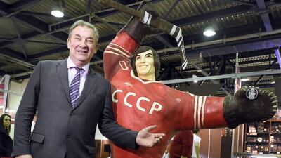 Soviet ice hockey legend Vladislav Tretiak poses next to his chocolate statue during the Salon du Chocolat opening night. Alexander Nemenov / AFP