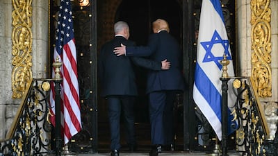 US President Donald Trump, right, and Israeli Prime Minister Benjamin Netanyahu walk inside Mr Trump's Mar-a-Lago residence in Palm Beach, Florida. AFP