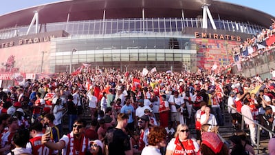 Arsenal fans celebrate outside the Emirates Stadium. PA