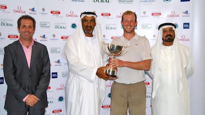 Luke Joy, winner of the Abu Dhabi Open receives his prize from Khalfan Al Kaabi, a board member of Emirates Golf Federation. Courtesy Mena Golf Tour