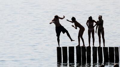 Teens play at a lake in Markkleeberg, eastern Germany. Jan Woitas/AP Photo