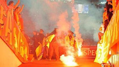 Galatasaray fans throw firecrackers onto the pitch and at police during the Uefa Champions League group D soccer match against Arsenal at Emirates Stadium in London, Britain, on October 1, 2014. EPA/GERRY PENNY