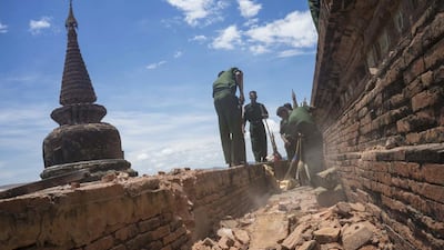 Military personnel clear debris at a temple that was damaged by a strong earthquake in Bagan, Myanmar on August 25, 2016. Two young girls and a man died in Magway region where the 6.8 magnitude quake struck. Hkun Lat/AP Photo