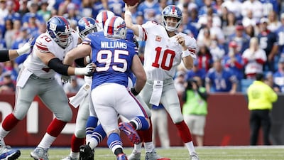 Kyle Williams of the Buffalo Bills tries to rush New York Giants quarterback Eli Manning during their NFL contest last weekend. Kevin Hoffman / USA Today Sports / October 4, 2015