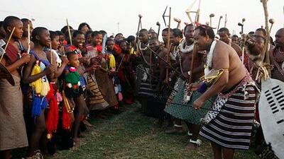 Swaziland's king Mswati III, right, dances with maidens during a reed dance in Mbabane. Themba Hadebe / AP Photo