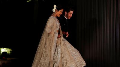 Newlyweds Priyanka Chopra, 36, and Nick Jonas, 26, pose for a photograph during a reception at a hotel in New Delhi on December 4, 2018. Photo: AFP