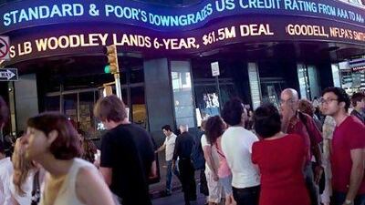 An ABC News ticker reads "Standard & Poor's downgrades US credit rating from AAA to AA+" in Times Square in New York City. The ratings agency decided to downgrade the US credit rating after the prolonged debt-limit debate in the US government. Andrew Burton/Getty Images/AFP