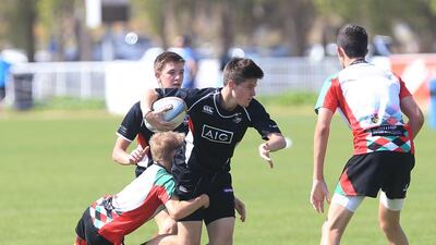 England international Ugo Monye interacts with children during his visit to the Etihad Airways Abu Dhabi Harlequins Junior Rugby tournament at Zayed Sports City in Abu Dhabi on Saturday. Ravindranath K / The National