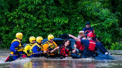 Commuters are rescued from a flooded car on Columbia Pike after a flash flood in Oakland Mills, Maryland, USA, 27 May 2018. The National Weather Service stated as much as 9.5 inches of rain fell in the area. Jim Lo Scalzo / EPA