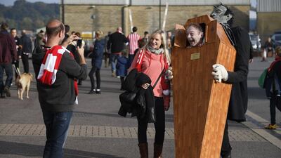 Fans in Halloween fancy dress outside the stadium before the match. Toby Melville / Reuters