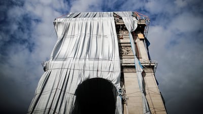 Technicians work to remove the fabric encasing the building, after it was wrapped for an art installation entitled 'L'Arc de Triomphe, Wrapped'. Reuters