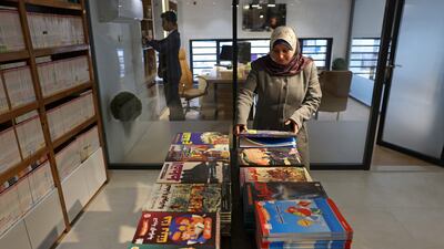 Workers prepare for the opening of the new Samir Mansour bookshop that was destroyed during last year's 11-day war between Israel and the Palestinian Hamas movement, in Gaza City. Mansour's beloved bookshop has been rebuilt and restocked following an international fundraiser.