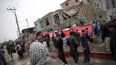 Residents look at the site of a suicide attack in eastern Kabul on March 2, 2018 that killed at least one person and wounded several others. Massoud Hossaini / AP Photo