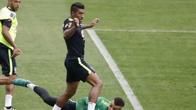 Brazil’s Paulinho and keeper Alex Muralha during training. Andre Penner / AP Photo