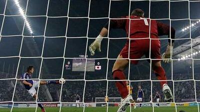 Japan's Tadanari Lee volleys the only goal past Australia's goalkeeper Mark Schwarzer during extra time in Doha last night.