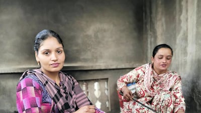 Amandeep Kaur's neighbour Harvinder Kaur helps her with cooking.