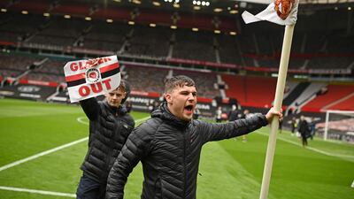 Manchester United supporters on the Old Trafford pitch before the game against Liverpool. AFP