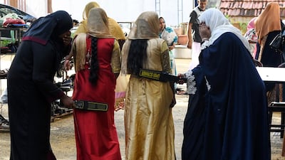 Sri Lankan Muslim women search devotees at the entrance of the Grand Mosque on the first day of Eid al-Fitr in Colombo. AFP