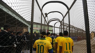 Prisoners, wearing jerseys in the colours of the Brazilian national football team, participate in the opening ceremony of their own version of the 2014 World Cup at the Castro-Castro prison in Lima, Peru on Monday. Mariana Bazo / Reuters / June 2, 2014