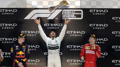 Lewis Hamilton, centre, celebrates on the podium after winning the 2019 Abu Dhabi Grand Prix. AP Photo