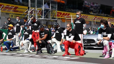 Formula One drivers including Lewis Hamilton, centre, and Sebastian Vettel, right, take a knee in support of the Black Lives Matter movement ahead of the Austrian Grand Prix at the Red Bull Ring.