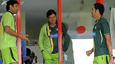 Misbah-ul-Haq, left, the Pakistan captain, talks with Mohsin Khan, centre, the Pakistan coach, and Umar Gul, right, during the Test match with Sri Lanka in Sharjah.