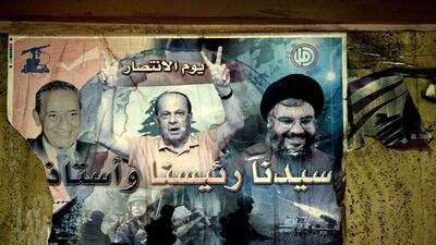 A 2011 photo shows a poster in Beirut of Lebanese opposition leaders, Parliament Speaker Nabih Berri, left, then MP Michel Aoun, centre, and Hezbollah chief Hassan Nasrallah. AFP