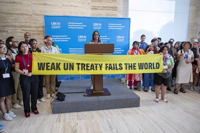 Activists stage a protest during a plenary session of Second Part of the Fifth Session of the Intergovernmental Negotiating Committee on Plastic Pollution at the European headquarters of the United Nations in Geneva. AP