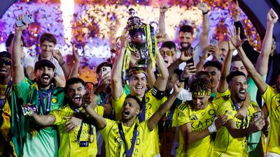 Al Nassr's Cristiano Ronaldo and team members celebrate winning the Saudi Pro League. Reuters