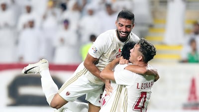 Mohammed Al Menhali, centre, of Al Wahda celebrates after scoring. Chris Whiteoak / The National