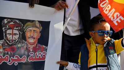 A child is pictured next to a poster representing Sudan's top army general Abdel Fattah Al Burhan (right) during a protest in Rome last week when the G20 leaders met. AFP