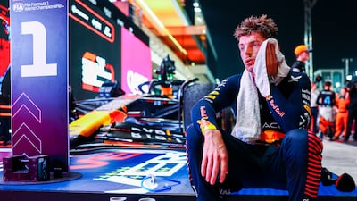 Race winner Max Verstappen of Red Bull wipes himself down with a towel after driving in 'extreme weather' conditions in Lusail. Getty
