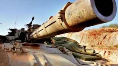 Point that thing somewhere else: An Israeli soldier sleeps atop a tank parked along the intercontinental border with Lebanon in August 2006.
