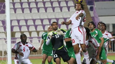 The UAE's Mohammed al Shihi rises to clear but Hussein Rehema bundled the ball over the line for Iraq's equaliser.