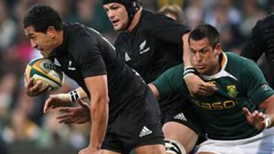 New Zealand's Mils Muliaina, leftt, tries to avade the clutches of South Africa's Pierre Spies during their Tri-Nations match in Bloemfontein, South Africa, last Saturday.