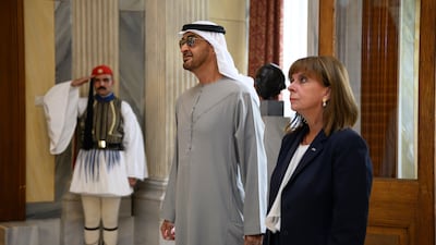 President Sheikh Mohamed Ms Sakellaropoulou stand for the UAE and Greek national anthems.