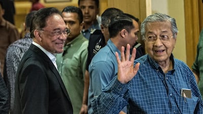 Mahathir Mohamad, right, and Anwar Ibrahim, left, have endured a very complicated relationship dating back four decades. Ahmad Yusni / EPA