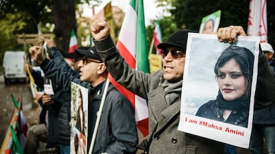 Protesters from the National Council of Resistance of Iran hold pictures of Mahsa Amini in front of the Iranian embassy in Berlin last month. EPA
