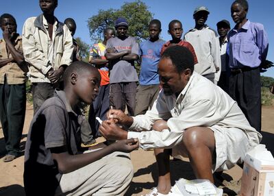 A Zambian healthcare worker tests for malaria in a village. Reuters