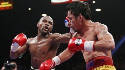 Floyd Mayweather, left, lands a shot on Manny Pacquiao during their Las Vegas bout. Esther Lin / EPA