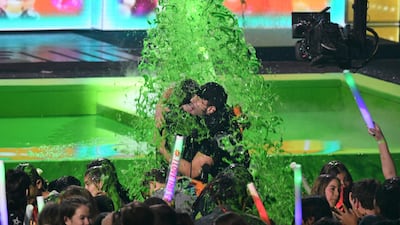 Favourite Social Star winner Slovakian YouTuber David Dobrik, left, and actor Josh Peck get slimed on stage. AFP