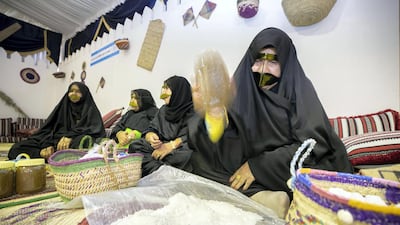 A lady crushes salt during the festival.