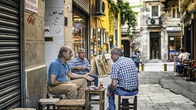 Men chat as they drink tea in Istanbul, Turkey. AFP