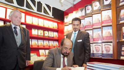 The Ruler of Sharjah, Dr. Sheikh Sultan bin Mohammed, signs his latest book, ‘Under the Flag of Occupation’ at the opening day of the Frankfurt Book Fair