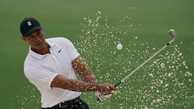 Tiger Woods hits out of a bunker on the 15th hole. AP
