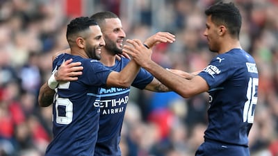 Riyad Mahrez, left, celebrates with Kyle Walker and Rodrigo after scoring City's fourth goal. Getty