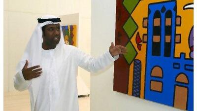 The artist Abdul Rauf Khalfan with one of his modular canvases in an exhibition at the Yas Hotel.