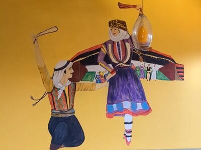 The 'dabkeh' performers are painted on a wall in Bawadi restaurant in Viriginia. Leen Alfaisal / The National