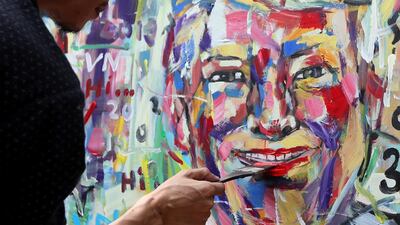 Vietnamese artist Tran Lam Binh puts finishing touches to his portrait of US President Donald Trump at a cafe in Hanoi, Vietnam. EPA